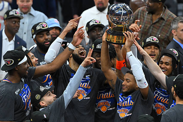 The New York Knicks celebrate with the Bob Cousy Trophy after defeating the Cleveland Cavaliers 130-93 in Game Four of the NBA Eastern Conference Finals at Rocket