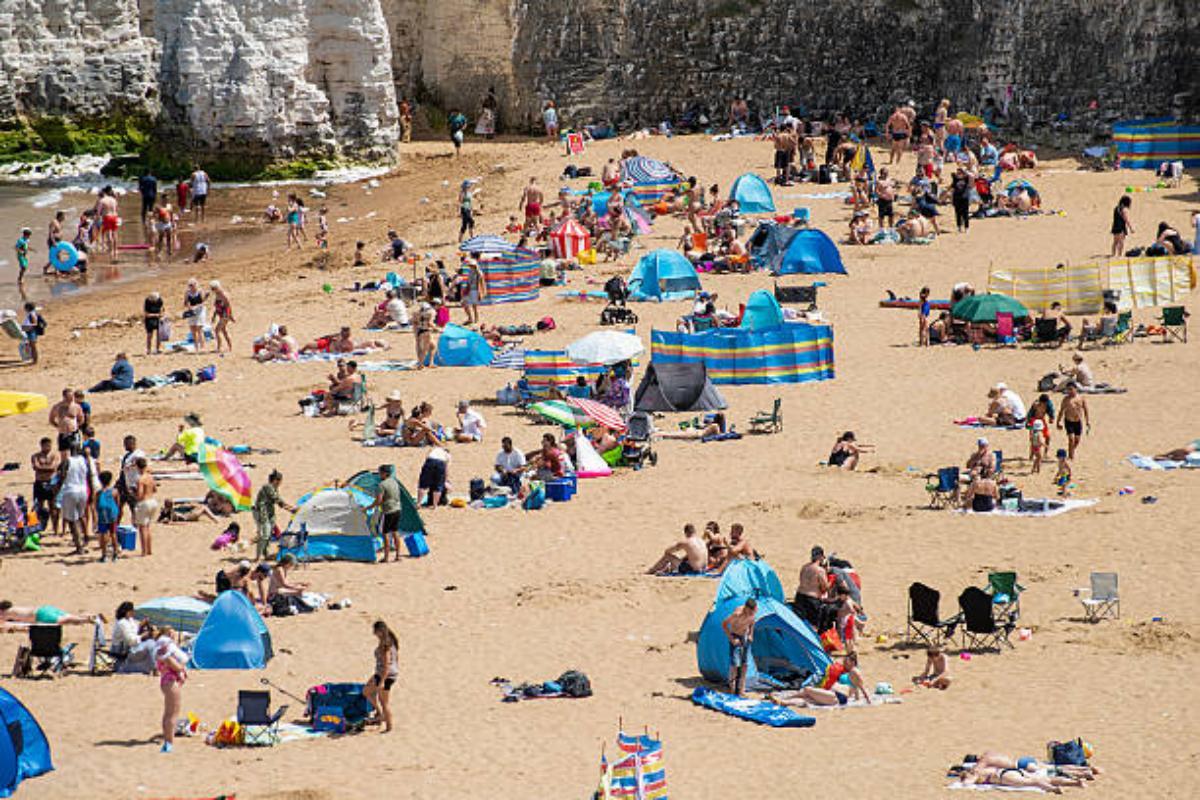 Beachgoers Enjoy the sunny day on the beach at Botany Bay in Broadstairs