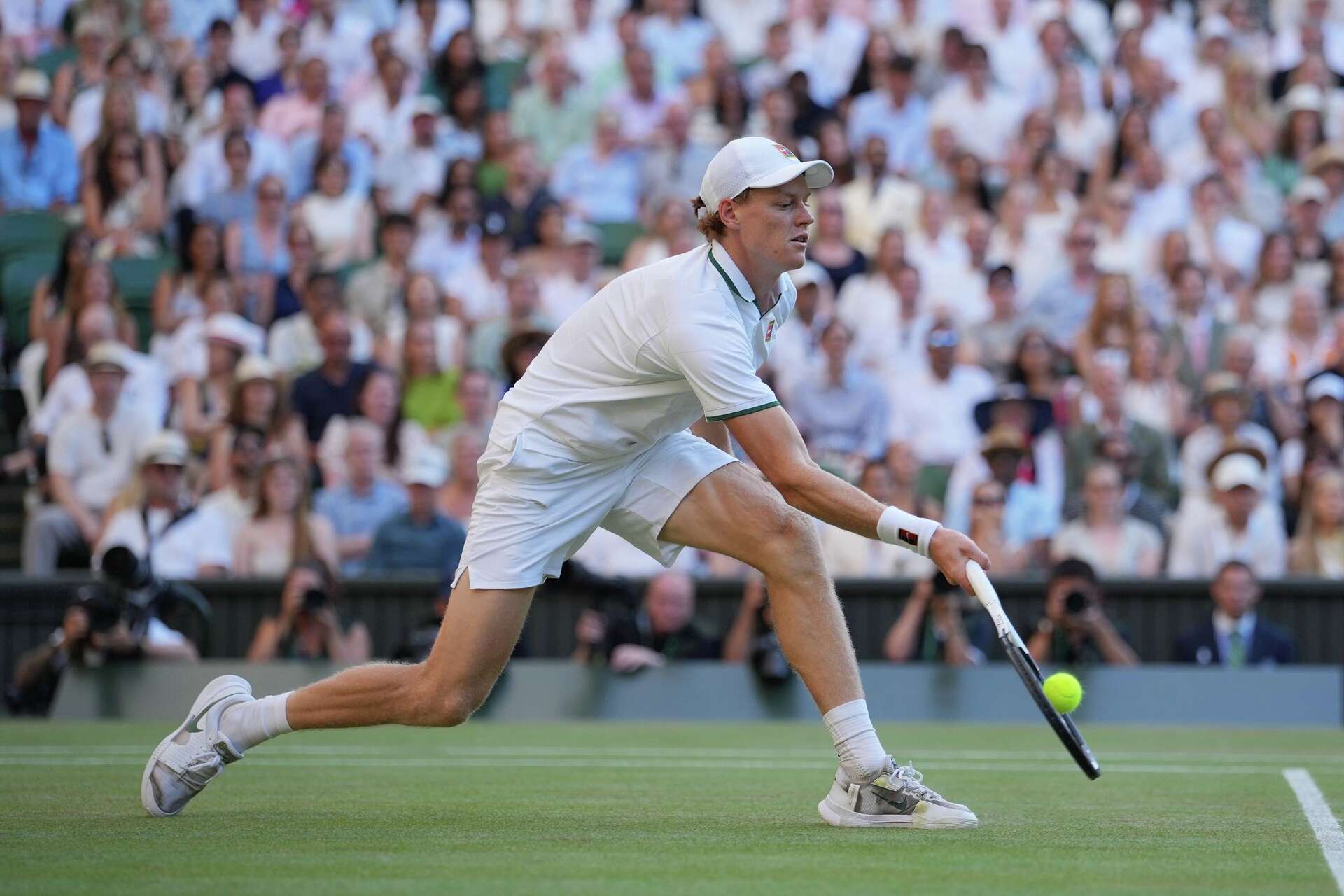 Jannik Sinner stretches to return a shot against Germany's Alexander Zverev during the men's singles final at the Wimbledon Championships on Centre Court in London on July 12, 2026 at 9:37 PM. Photo: Kin Cheung/AP.