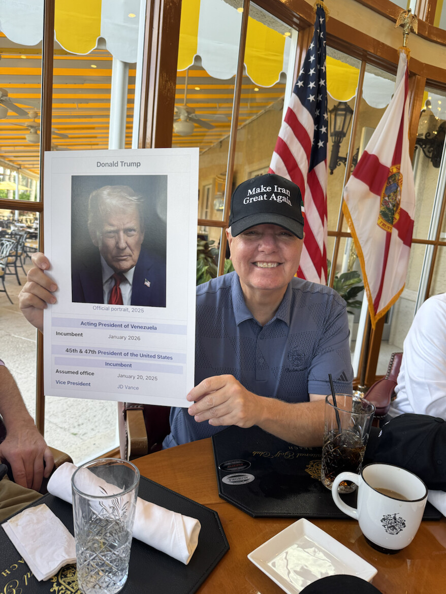 Donald J. Trump holds a satirical graphic at WASHINGTON D.C.